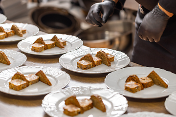 Image showing Chef plating slices of toasted bread and ground meat