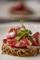 Image showing Smoked bacon slices on rye bread