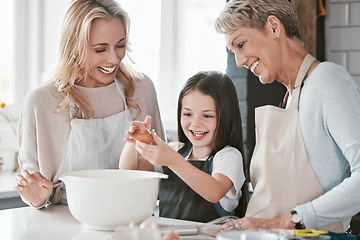 Image showing Family, baking and child helping mother and grandmother with cooking with an egg in bowl for future as chef or baker. Woman, senior woman and girl learning to make cake, food or breakfast in kitchen