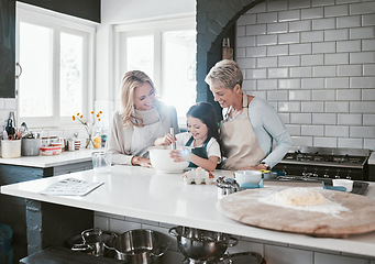 Image showing .Happy, joyful and loving mother and grandmother cooking, baking and preparing food with their daughter and grandchild. Happy, cheerful and carefree girl learning to bake with her family in kitchen.