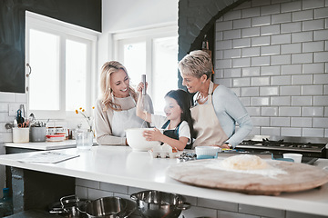 Image showing .Grandmother, mother and girl baking in kitchen having fun, bonding and spend quality time together. Family, love and grandma and mom teaching child how to cook, bake and develop chef skills at home.