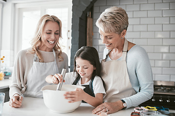 Image showing .Family, children and baking with a mother, grandmother and girl in the kitchen of their home together. Food, kids and bake with a woman, parent and female child learning about cooking while bonding.