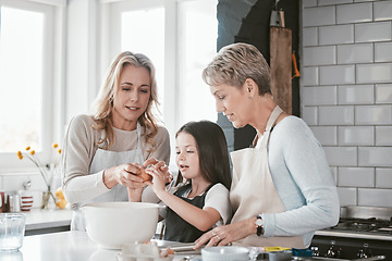 Image showing .Baking, learning and child with mother and grandmother in the kitchen for breakfast in their house. Cooking, food and girl kid with her mom and a senior woman teaching to cook or bake as a family.