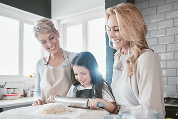 Image showing Baking, bonding and child with mother and grandmother in the kitchen learning to bake in their house. Food, love and girl kid with a smile with mom and senior woman teaching to cook together