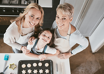 Image showing Baking, above and girl with mother and grandmother in the kitchen for cookies in their house. Cooking, bonding and portrait of a child with mom and senior woman learning to bake in their family home
