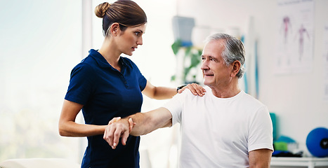 Image showing Physiotherapy doctor, senior patient and stretching arm, physical therapy or orthopedic healthcare in clinic. Physiotherapist, chiropractor and nurse help old man with rehabilitation, muscle and body