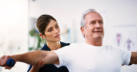 Image showing Physical therapy, exercise and physiotherapist with a senior man helping him heal at a rehabilitation clinic. Healthcare, wellness and elderly guy doing a workout with weights in physiotherapy class.