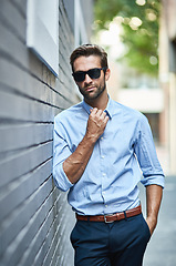 Image showing Business fashion, confidence and portrait of man with glasses, professional clothes and leaning on city wall. Designer outfit, luxury apparel and businessman with cool attitude, style and formal wear