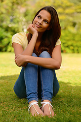 Image showing Thinking, relax and woman in a park for freedom, motivation and smile on the grass in nature. Calm, peace and girl with an idea during a holiday or vacation in a natural environment or lawn in summer