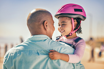 Image showing Family, love and girl with dad and helmet for safety before cycling together at park outdoors, happy and hug. Children, learning and father embrace daughter, bonding and talking before riding a bike