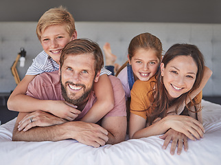 Image showing Happy, relax and portrait of family in bedroom for bonding, support and smile together. Affection, playful and weekend with parents and children at home for natural, rest and embrace in the morning