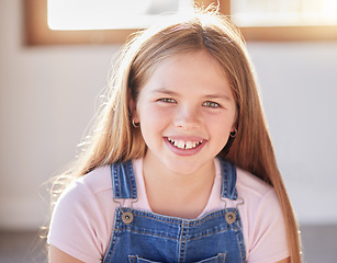 Image showing Portrait, happy and girl relax at a window in a living room, cheerful an excited while sitting alone in her home. Face, child and preteen female with positive mindset relaxing with a cute smile