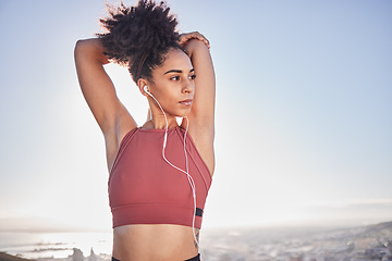 Image showing Fitness, exercise and black woman stretching and listening to music with earphones while at the beach for a workout and training. Sports model outdoor in nature for energy, health and wellness