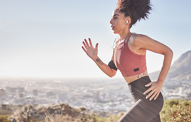 Image showing Fitness, earphones and woman running in nature for health, wellness and exercise while listening to music. Motivation, sports and girl doing outdoor training for a marathon, race or competition.