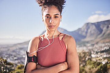 Image showing Fitness, exercise and black woman outdoor listening to music with earphones for motivation, energy and performance against a mountain background. Portrait of sports model in nature for cardio workout