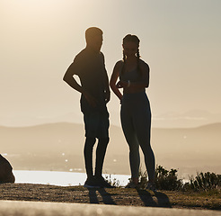 Image showing Fitness, couple and checking time for running, exercise workout or sports training on a mountain in the outdoors. Man and woman silhouette in wellness for healthy run and monitoring performance