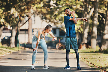 Image showing Fitness, stretching and couple rest in park after running, exercise and workout together in city. Health, wellness and interracial couple and doing training, sports and check time for performance