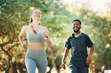 Image showing Running, fitness and fun with a diversity couple outdoor in the park together for exercise or a workout. Health, training and laugh with a male and female runner bonding together in cardio sports