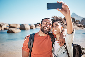 Image showing Couple, love and phone selfie on beach for travel adventure or summer vacation. Happy man, woman smile and photography for holiday lifestyle on 5g smartphone for social media at ocean water outdoors