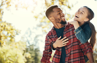 Image showing Couple, hug and smile while outdoor with love and care in nature, happy together while bonding in park. Black man, woman and interracial, hugging in relationship and marriage with romance mock up.