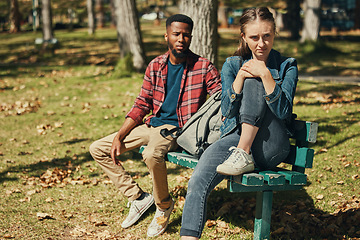 Image showing Angry, fight and interracial couple in conflict in a park with stress about divorce, mental health and marriage fail. Depression, sad and black man and woman frustrated with a problem in nature