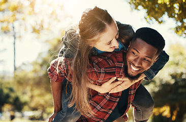 Image showing Love, piggy back and couple in park walking, smile and happy together, for bonding and outdoor. Romantic, interracial man and woman or loving on spring vacation, holiday and romance for relationship