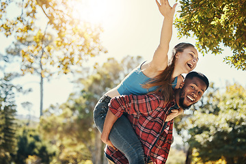 Image showing Diverse, couple and piggyback fun with a man and woman having fun in nature during summer. Adventure, happy couple and interracial people in a green garden or natural environment with happiness