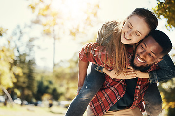Image showing Love, care and interracial couple with piggyback in a park for support, adventure and happy with mockup and bokeh. Hug, smile and black man and woman on an outdoor date in nature with space in summer