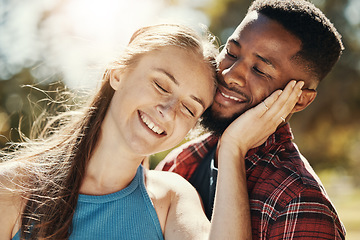 Image showing Park, love and interracial young couple enjoying weekend, holiday and summer vacation together. Bonding, affection and happy black man and white woman embrace, hugging and smiling outdoors in nature