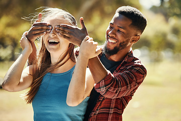 Image showing Diverse, couple and man and surprise woman by covering her eyes in a nature park. Shock, wow and people having fun for anniversary surprise in a natural evironment with boyfriend and girlfriend