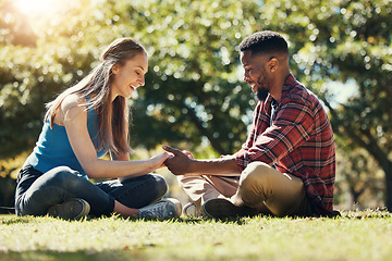 Image showing Couple, park and love while outdoor in nature for freedom, support and trust in marriage partner while on grass feeling happy. Interracial man and woman together on lawn for a date and quality time