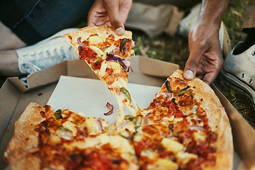 Image showing Pizza, food and hands of a couple eating in a park, picnic and relax on an outdoor date together. Hungry, fast food and zoom of man and woman with lunch or dinner in nature for peace and calm