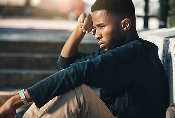 Image showing Depressed, angry and black man upset, tired and unhappy outdoor in city, stare and frustrated. Mental health, African American male and young guy with problem, fail and depression being disappointed.