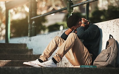 Image showing Student, mental health and depression with anxiety, burnout and sad for exam results, fail or mistake while sitting outdoor. Young man, stress and tired and depressed on university or college campus