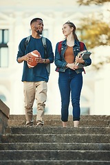 Image showing Couple, friends or students walking in stairs of university, college or campus with books or football ball. Education, sports or man and woman with communication, networking or school study review