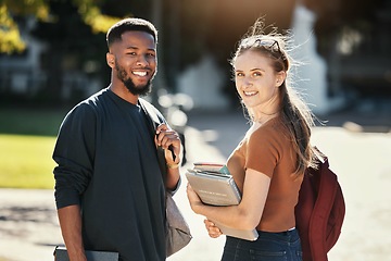 Image showing Students, couple or university friends walking together with books for education and learning on campus with scholarship. Portrait of an interracial man and woman together on college or school ground