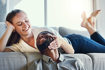 Image showing Affection, happy and interracial couple with love, care and smile in the living room of their house. Relax, peace and woman embracing face of a man with happiness and calm on the sofa of an apartment
