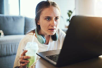 Image showing Laptop, smoothie and blog with a woman freelance entrepreneur doing remote work from home online. Computer, detox and email with a female blogger working in the living room of a house with headphones