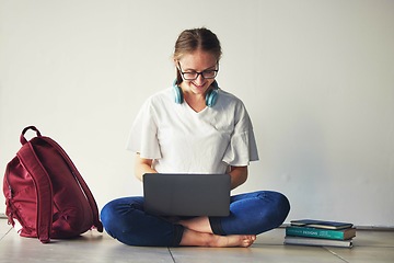 Image showing Education, laptop and woman with books on a floor for research, examination and preparation, happy and motivation. Student, girl and online university assignment, book and literature study project