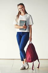 Image showing Studying, books and student at a college for education, knowledge and scholarship with a smile. School, happy and portrait of a girl ready for university with backpack on campus for higher education