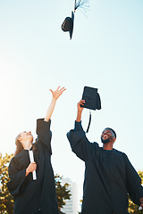 Image showing University, graduation and students with graduation cap in air for celebration, happiness and joy. College, education and man and woman throw hats after achievement of degree, diploma and certificate