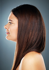 Image showing Hair care, woman on blue background or side profile of salon styling with straight hairstyle in studio. Advertising beauty product, healthy clean balayage on brunette color or hair texture shine