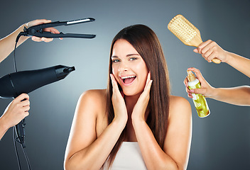 Image showing Hair, tools and portrait of woman with haircare products for beauty, cosmetology and wellness on a grey studio background. Brush, hairdryer and spray for hairstyle and hair treatment in a salon