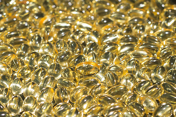 Image showing Fish oil capsules spilled to make a background