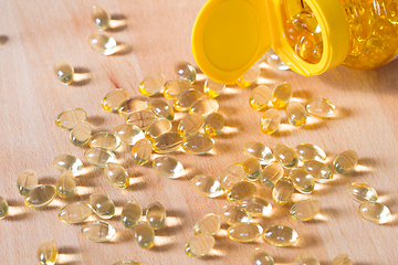 Image showing Fish oil omega pills spilled from a bottle