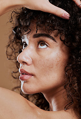 Image showing Beauty, skincare and natural hair of a young woman in studio for cosmetics, makeup and hair care for health and wellness. Face glow of a female after a facial with dermatology cream for acne skin