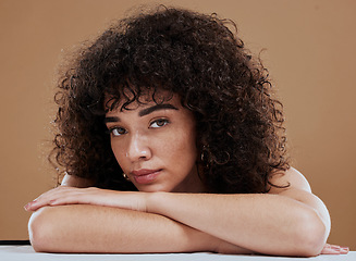 Image showing Face, beauty and skincare with a model black woman in studio on a brown background for natural haircare. Portrait, cosmetics and wellness with an attractive young female posing to promote hair care