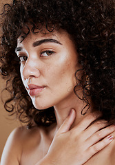 Image showing Skincare, hair care and face of a woman with makeup, beauty and natural glow against a brown studio background. Salon, luxury and portrait of a model with cosmetics and wellness care for afro hair