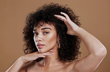 Image showing Face, skincare and hair with a model black woman in studio on a brown background for natural keratin treatment. Facial, wellness and eyes with an attractive young female posing for luxury cosmetics