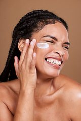 Image showing Beauty, face cream and woman in studio, happy and relax with skincare, pamper and cleaning on brown background. Facial, sunscreen and face of black woman for self care with skin, product and cosmetic